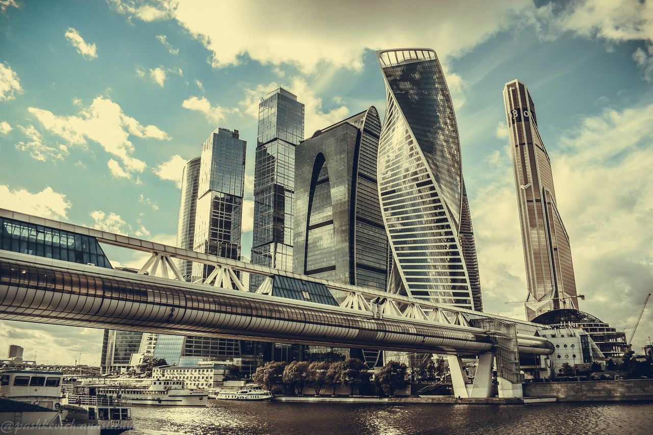 Moscow City skyscrapers and a covered bridge across the river