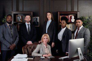 A team of professionals in business attire standing together in an office