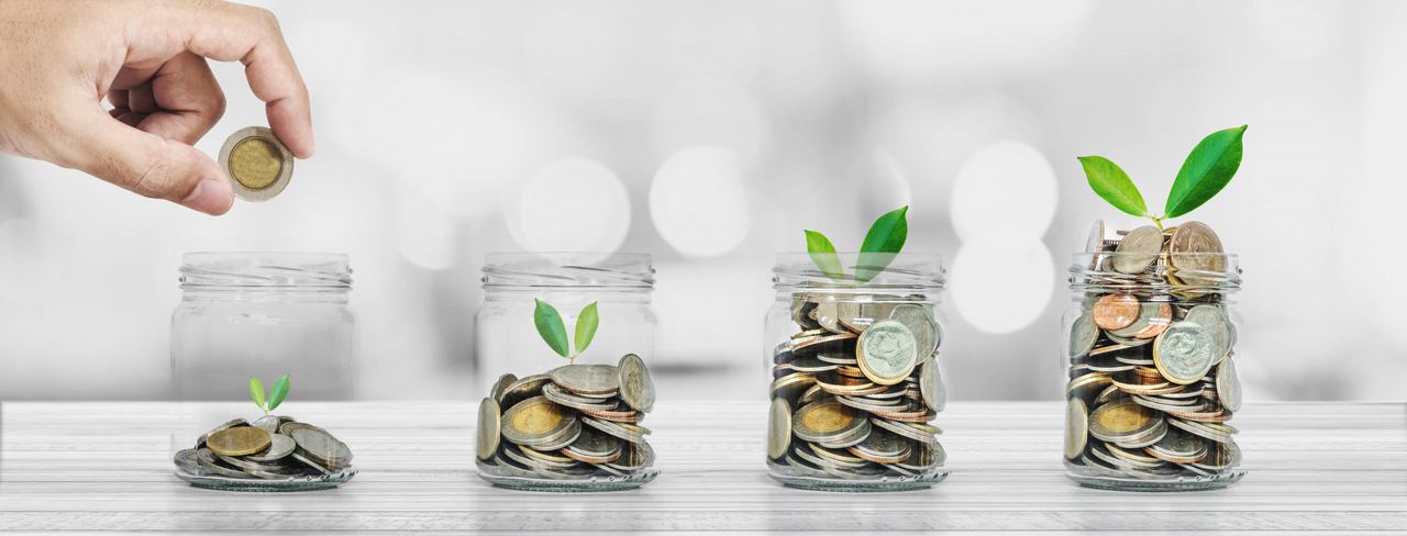 Coins in glass jars with small plants growing from them
